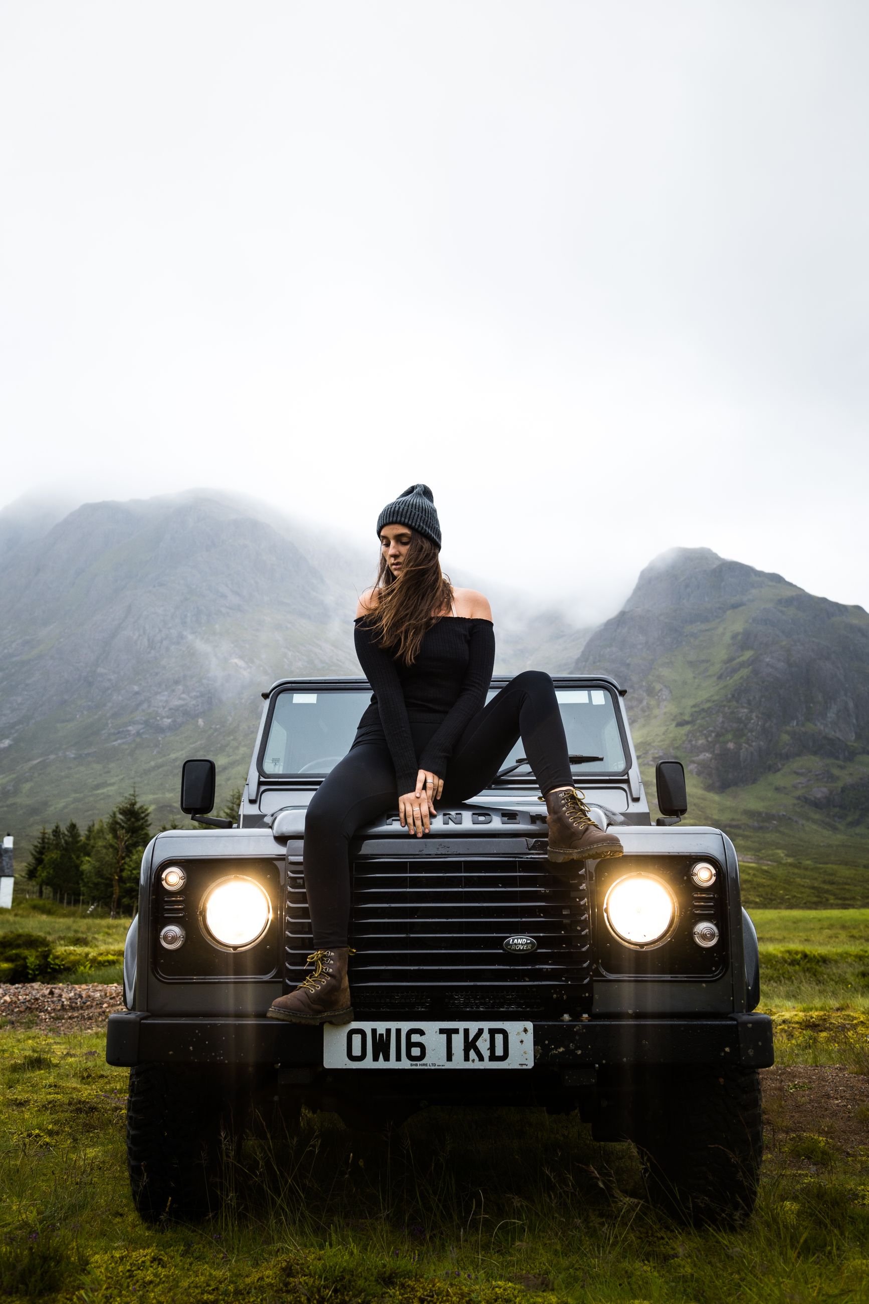 Women sitting on the bonnet of a Land Rover.