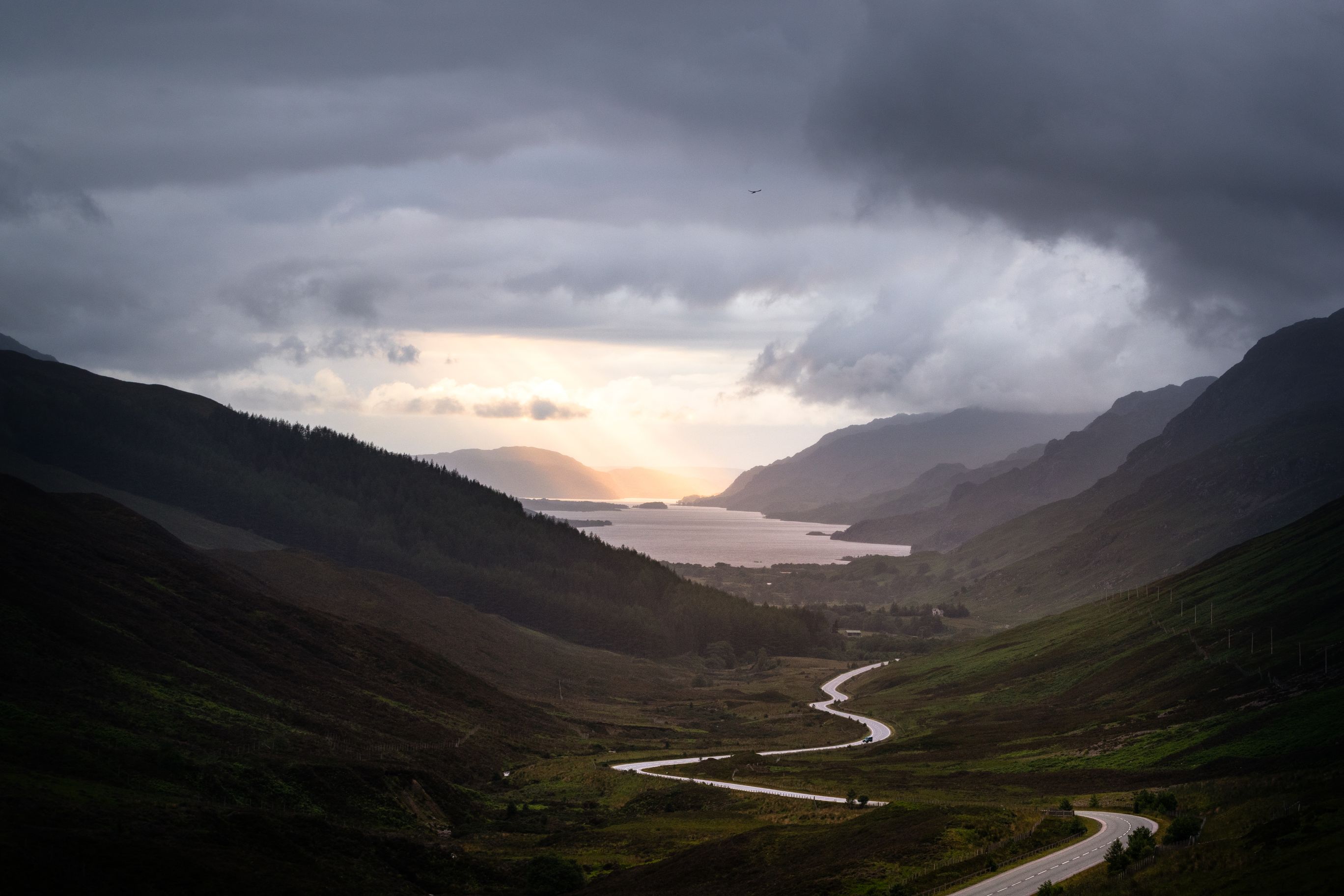 Winding road in a valley between mountains. 
