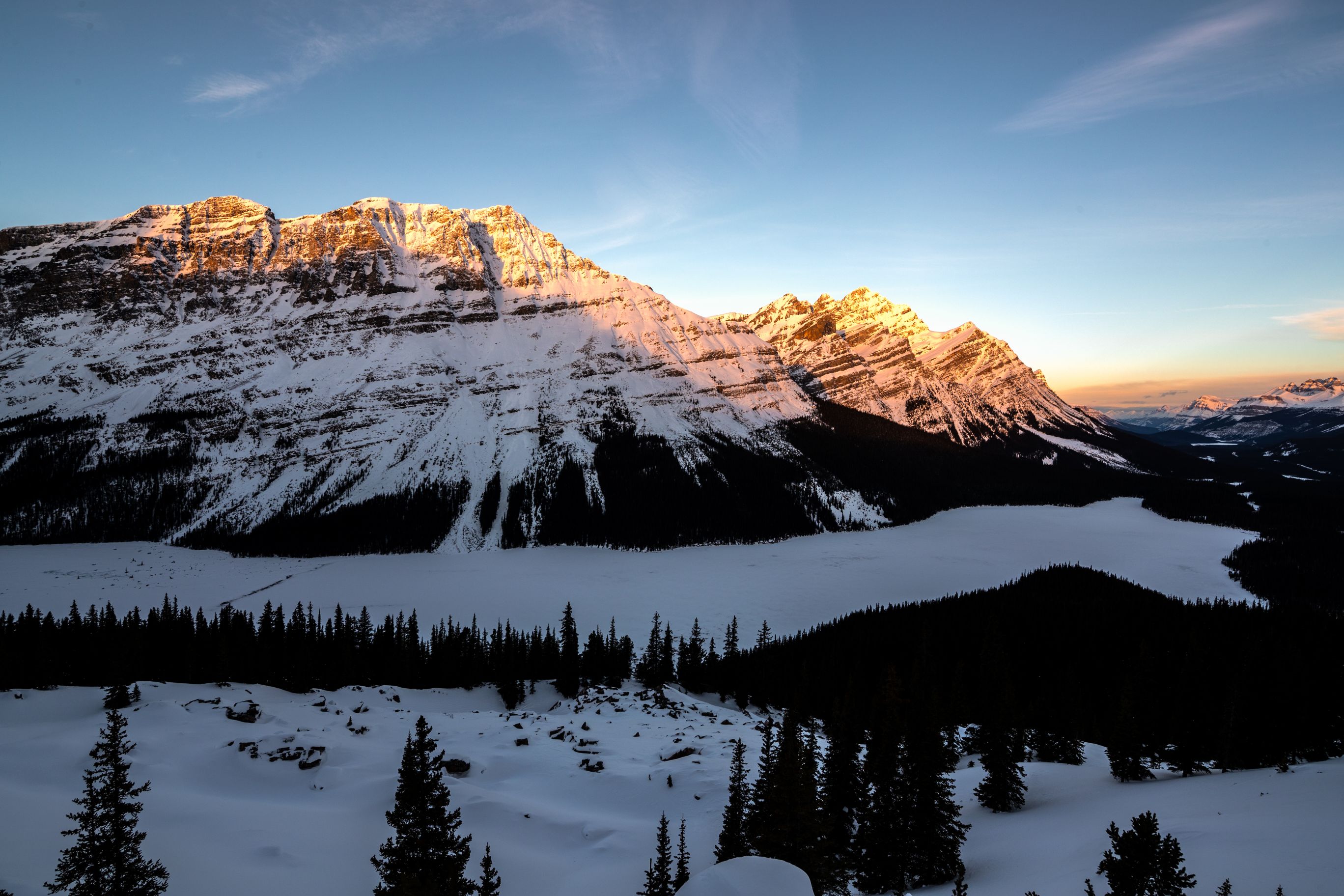 Sunset over frozen lake in the Canadian Rockies.